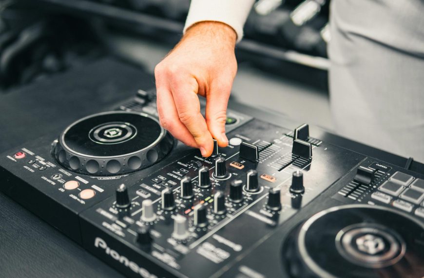 Windows 11 kontrolery DJ problem - Close-up of a DJ's hand adjusting a mixer at a live music event, showcasing professional s